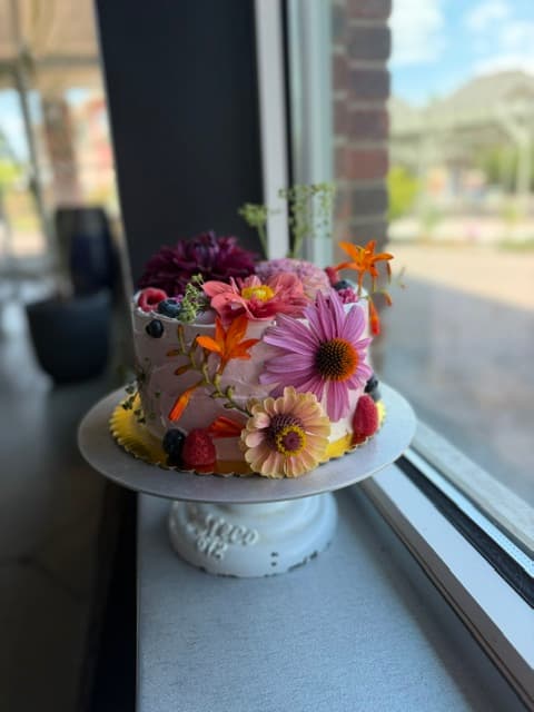 Floral cake on windowsill